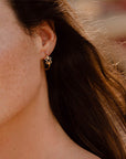 ragazza indossa piccoli orecchini cerchio oro giallo ghirigori fatti a mano italia
